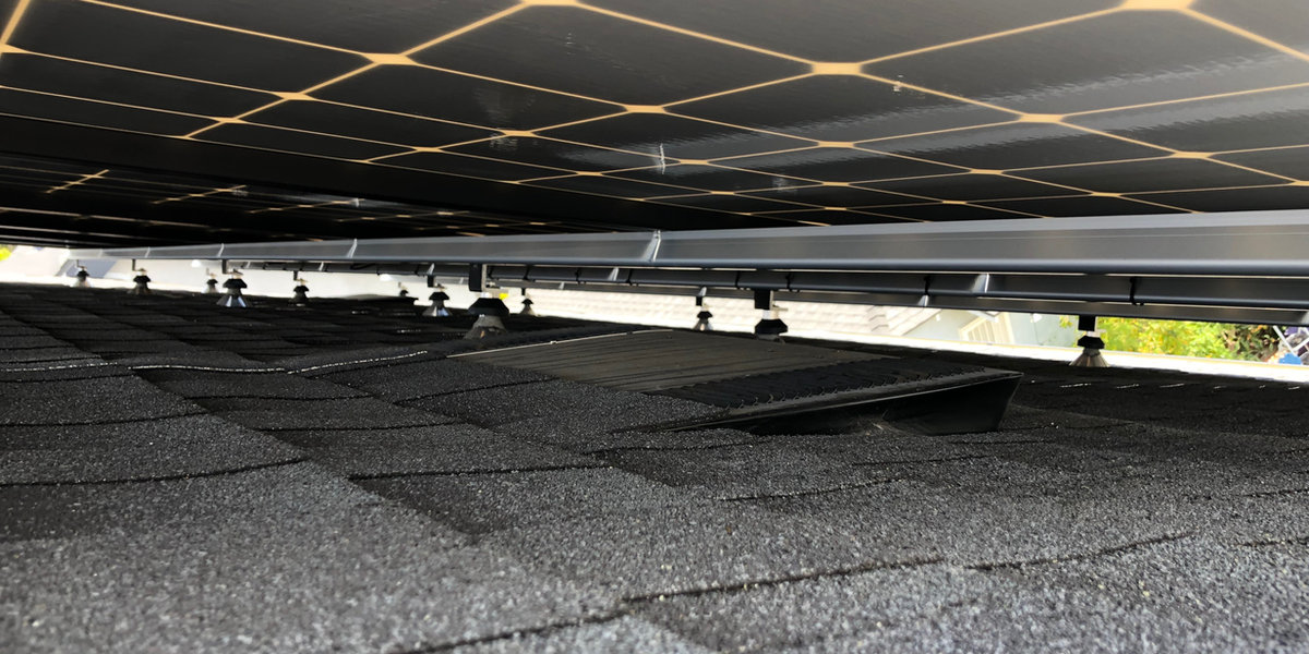 Wiring management beneath installed solar panels